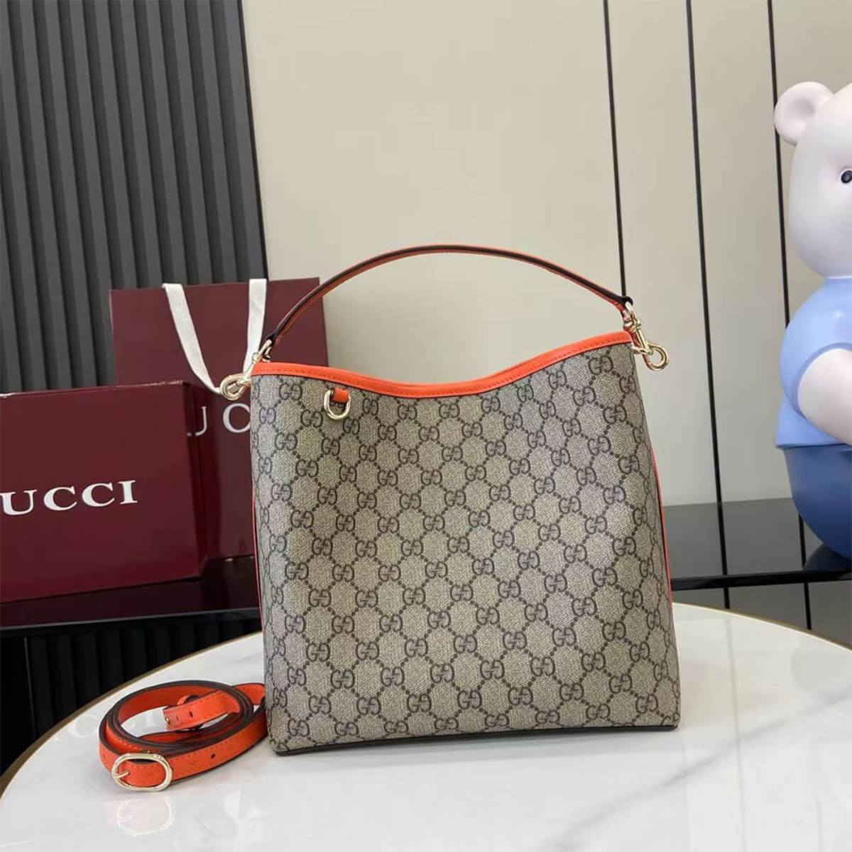 MEDIUM GG EMBLEM BUCKET BAG GUCCI